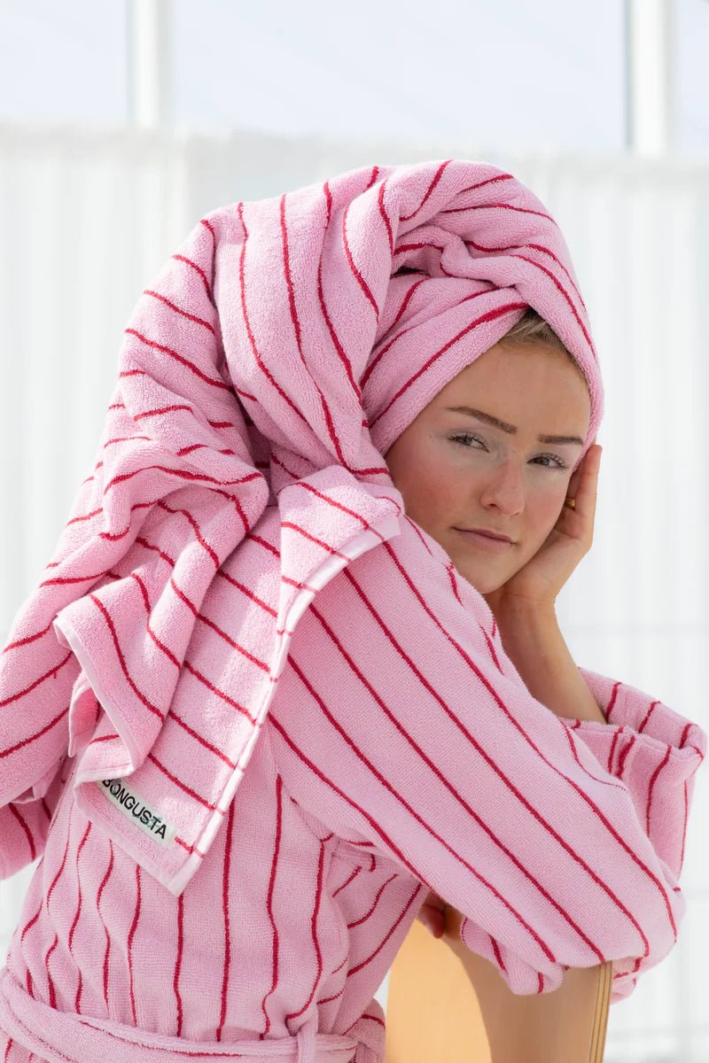Soft baby pink Naram towel by Bongusta, designed for bathroom use, with a plush texture and stylish ski patrol accents.