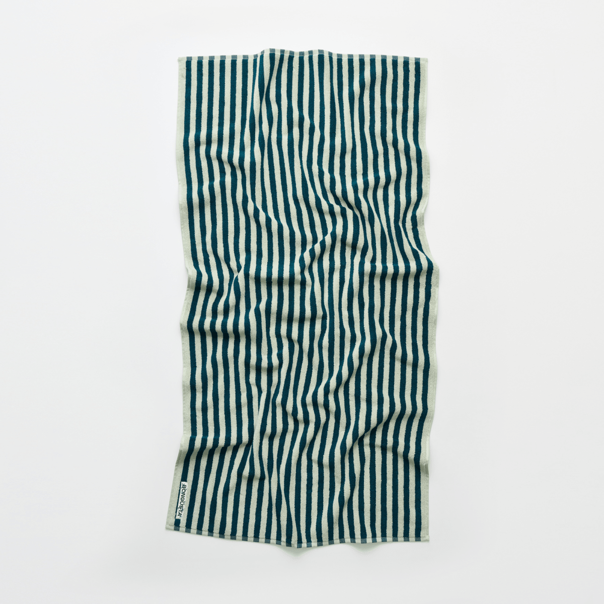 Sea foam and deep teal Naram bathroom towel by Bongusta, showing soft, plush fabric and vibrant color details.
