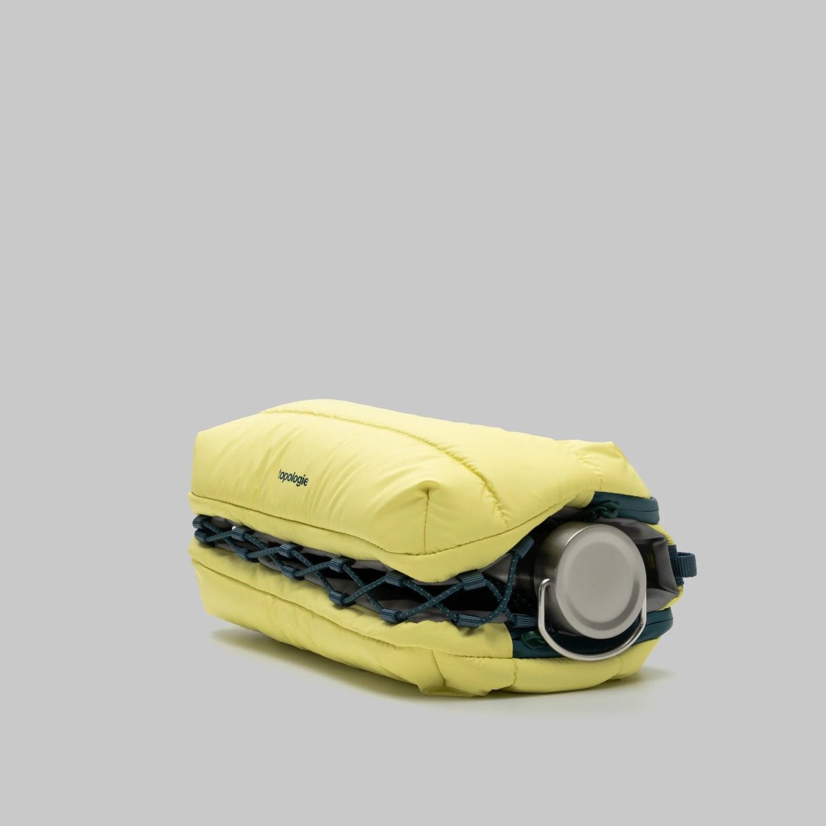Canary yellow puffy bottle bag from Topologie on a gray background