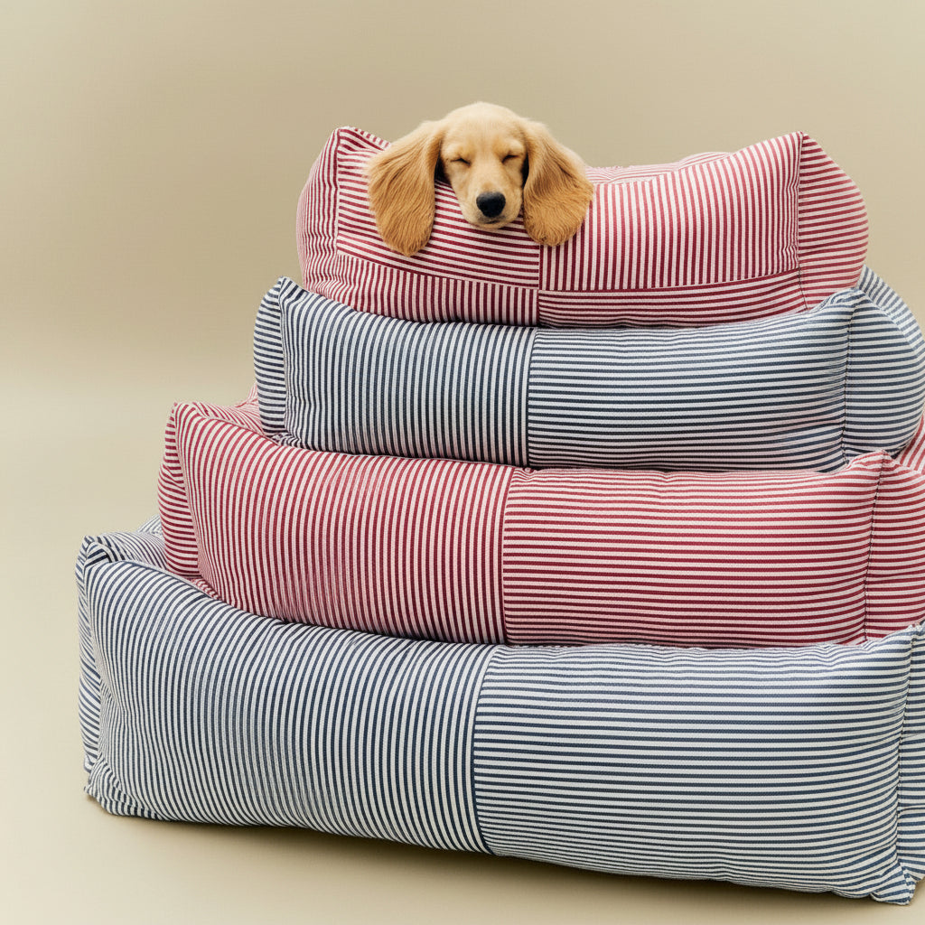 Stack of striped pet beds with a small dog peeking out from the top one.
