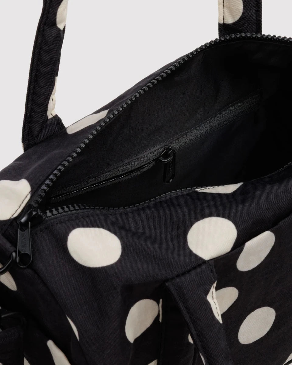 Black and cream polka dot nylon duffle bag from Baggu, stylish and spacious for travel or gym use.