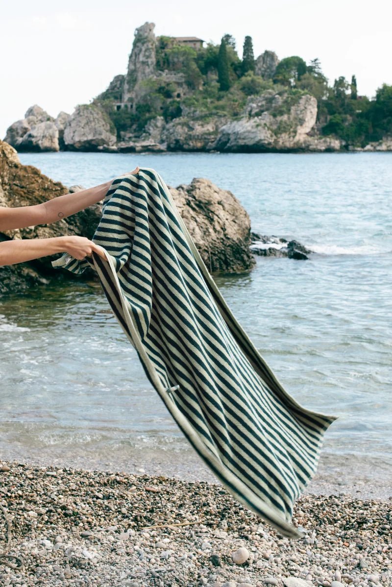Bongusta Naram bathroom towel in sea foam and deep teal displayed in a bathroom setting with a relaxed lifestyle scene.