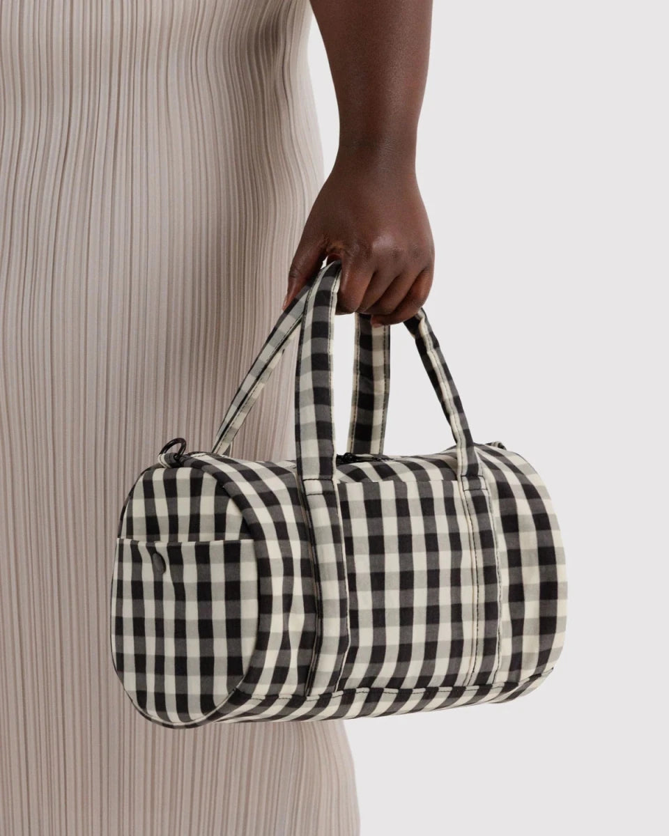 Black and cream gingham nylon duffle bag by Baggu, with sturdy handles and spacious interior for travel or gym use.