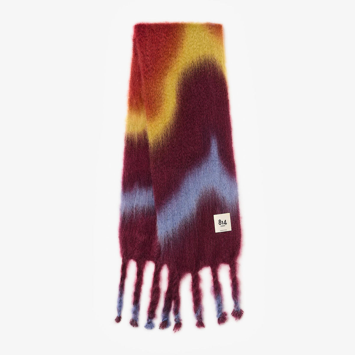 Colorful tie-dye mohair fringe scarf by 814 Ezcaray with berry pink and purple hues, showcasing soft fabric and fringed edges.
