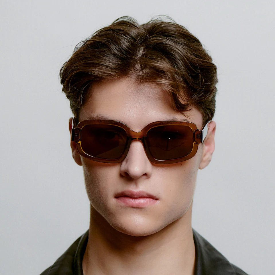 A. Kjaerbede Pluto sunglasses with dark tinted lenses and sleek black frames, stylish eyewear for sun protection.