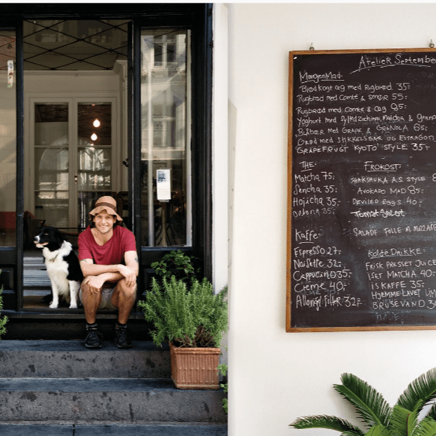 Open book titled "Atelier September: A Place For Daytime Cooking" by Apartamento, showcasing recipes and culinary inspiration.