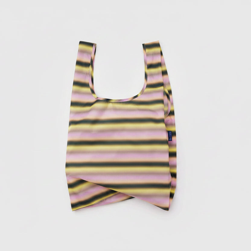 Striped reusable bag with a brand label on a white background