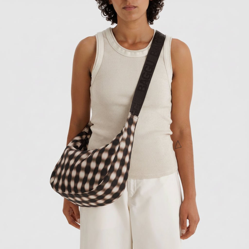 Baggu Crescent Shoulder Bag in soft fabric with adjustable strap, featuring a sleek, curved design and spacious interior.