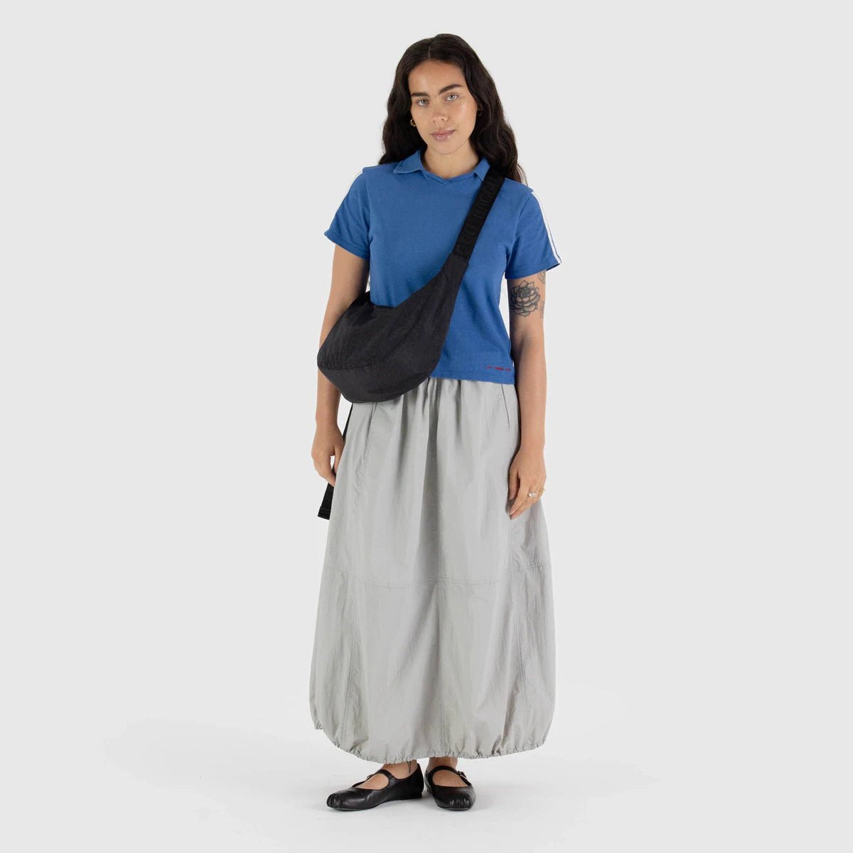 Baggu Crescent Shoulder Bag in neutral fabric with adjustable strap, showcasing versatile and stylish carry option.
