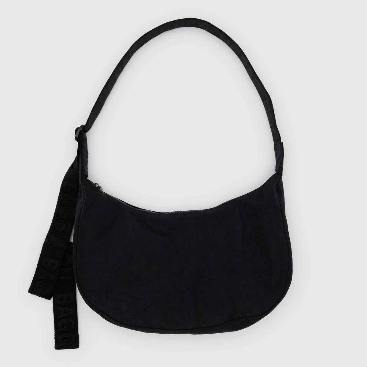 Baggu Crescent Shoulder Bag in soft fabric with adjustable strap, featuring a sleek, modern design for everyday use.