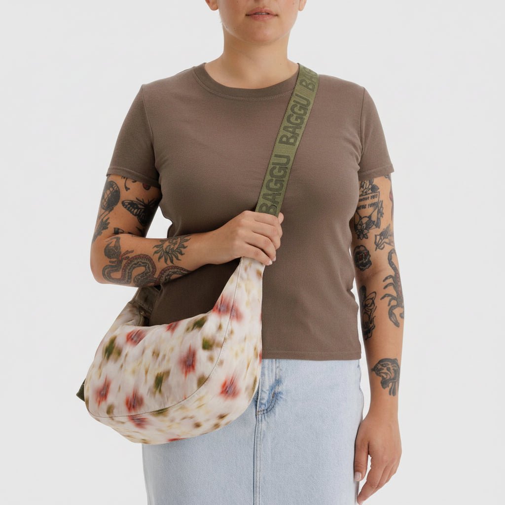 Baggu Crescent Shoulder Bag in soft fabric with adjustable strap and rounded shape, ideal for everyday use.