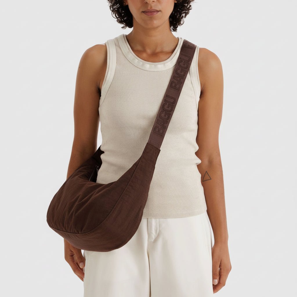 Baggu Crescent Shoulder Bag in neutral fabric with adjustable strap, featuring a sleek, compact design for everyday use.