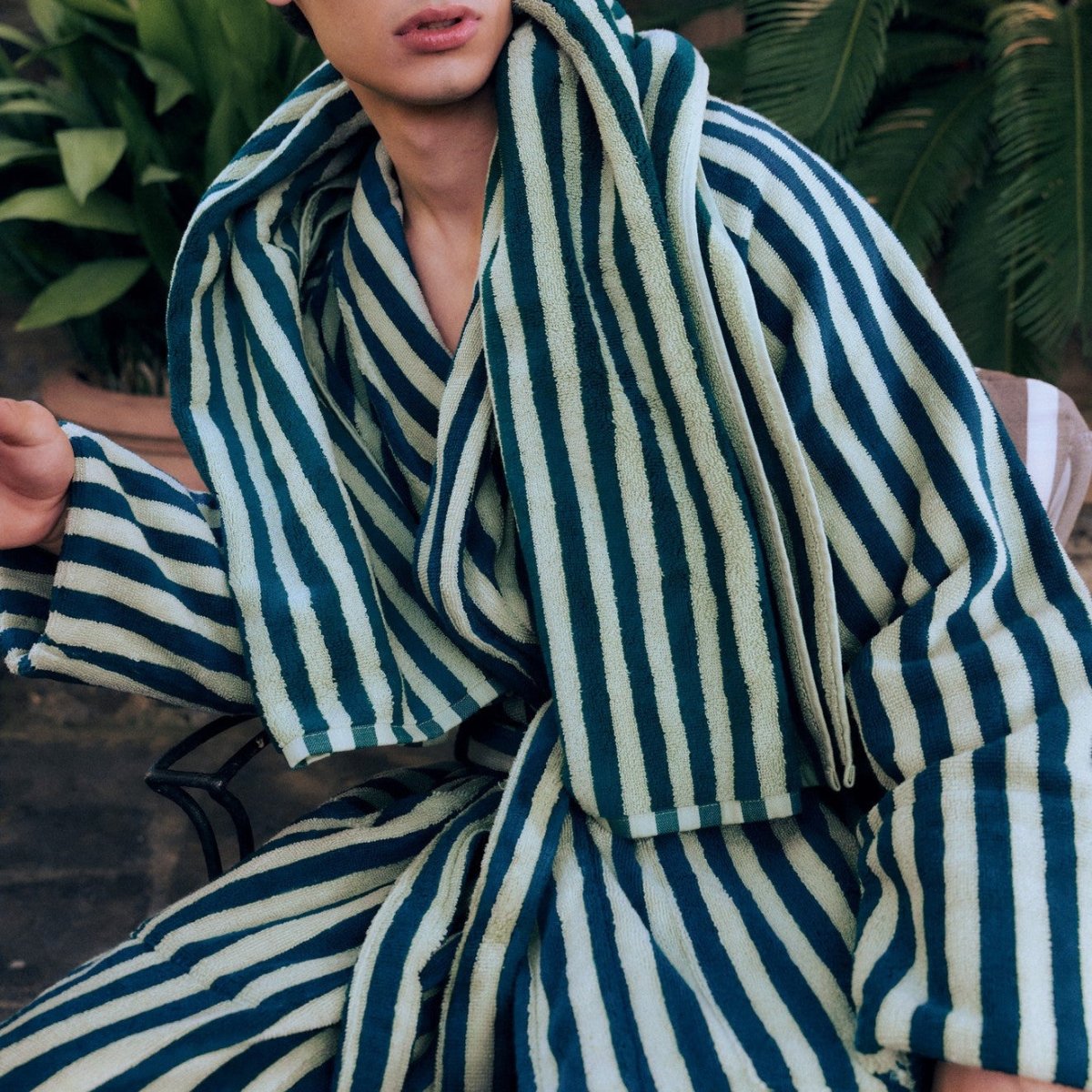 Bongusta Naram bathrobe in sea foam and deep teal, soft bathroom robe with plush fabric and relaxed fit, hanging on a hook.