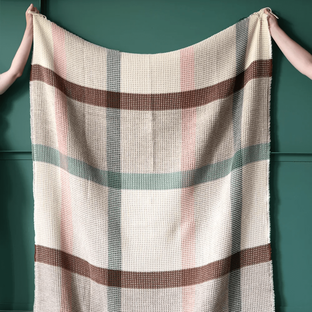 Multicolor Eucalyptus Manta Waffle throw blanket by Burel Factory, showing soft, textured fabric with a vibrant woven pattern.