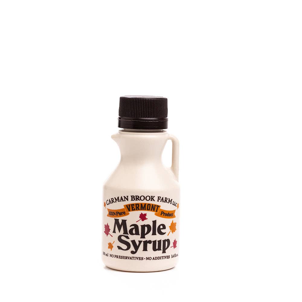 Carman Brook Farm Vermont Maple Syrup in a half-pint jar, displaying amber rich taste and golden syrup consistency.
