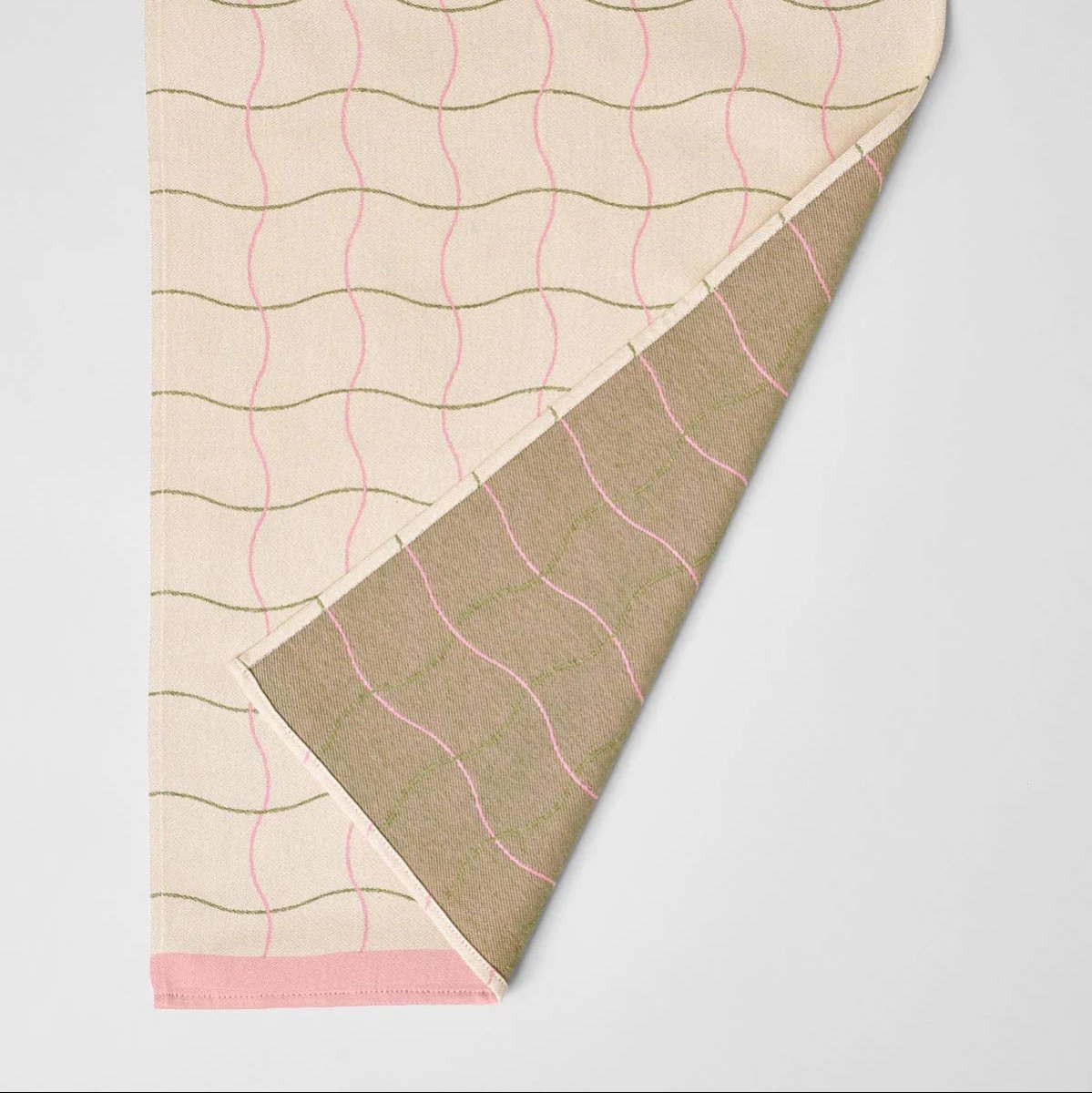 Folded fabric with wavy pattern on a light gray background