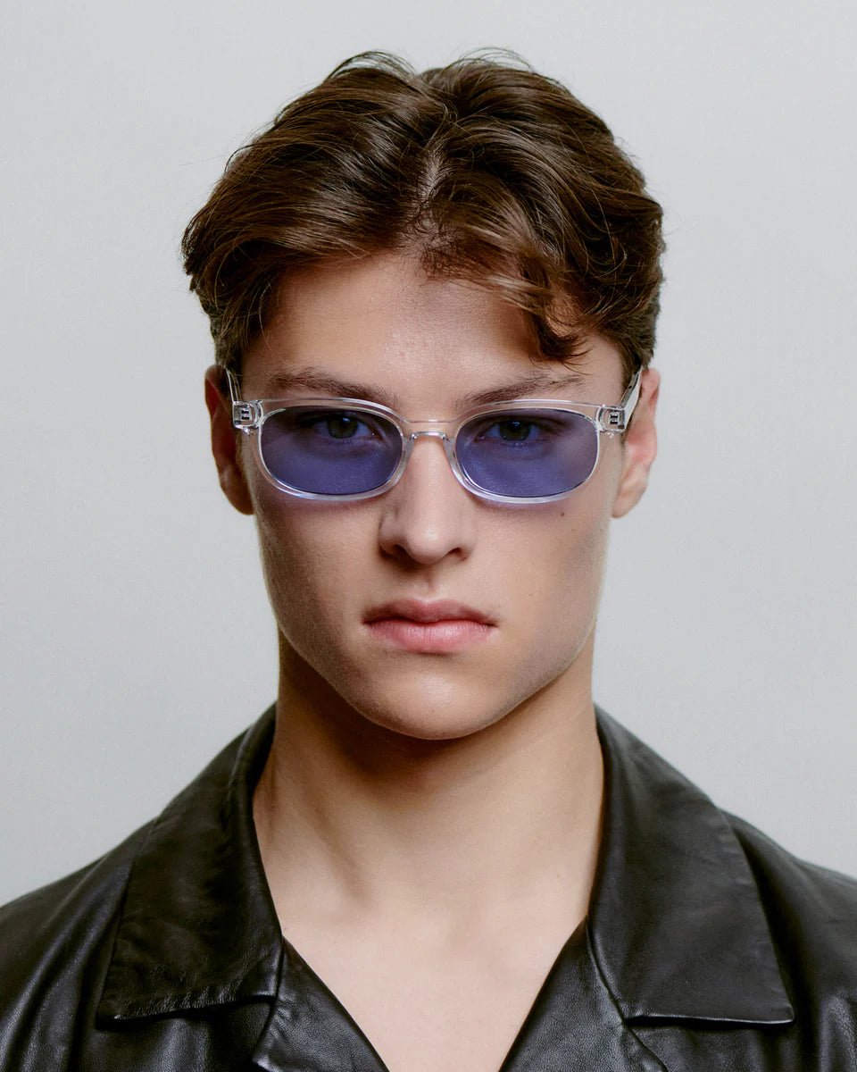 A. Kjaerbede Charlie sunglasses with clear crystal frames and dark tinted lenses, stylish eyewear for sun protection.