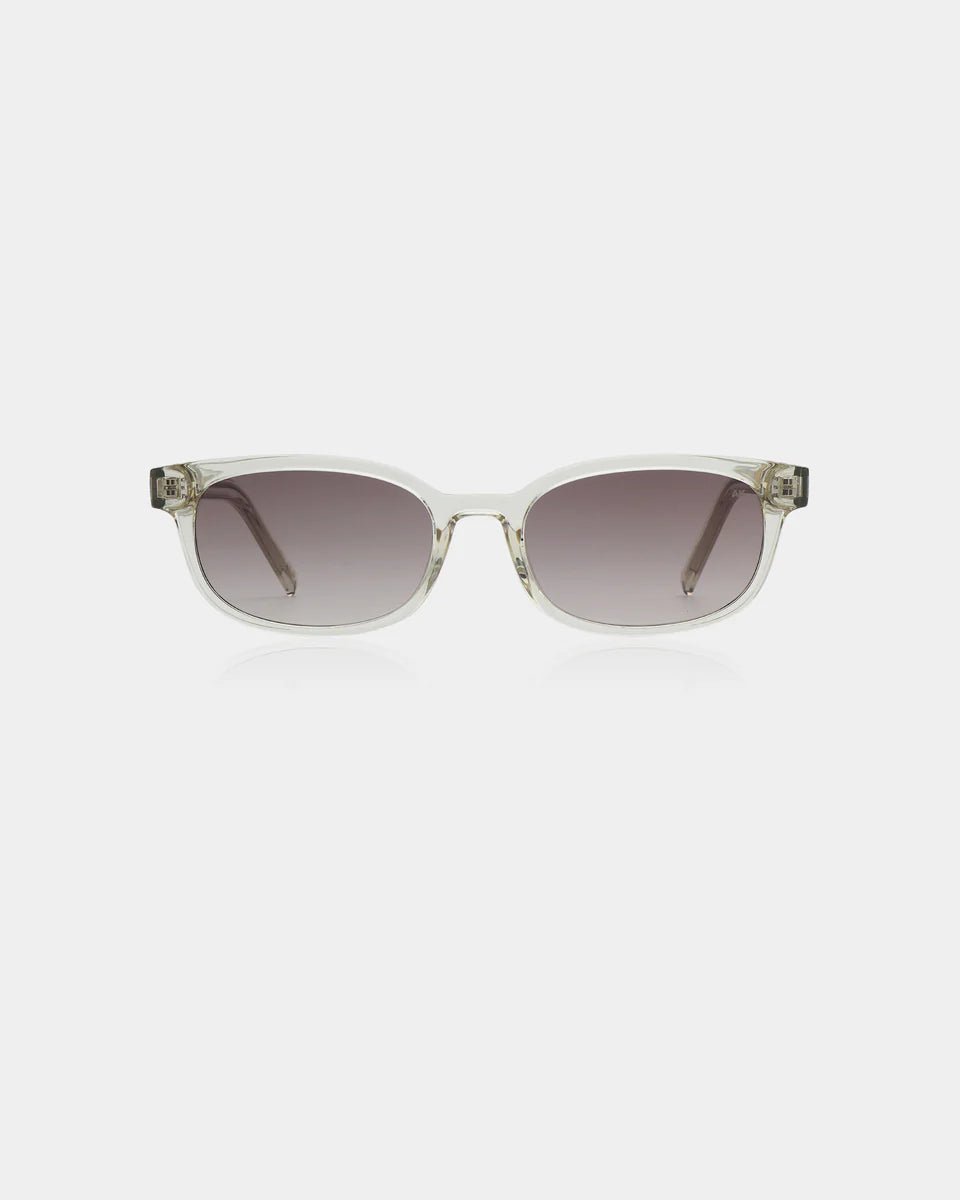 Ecru transparent Charlie sunglasses by A. Kjaerbede with round frames and tinted lenses sitting on a white surface.
