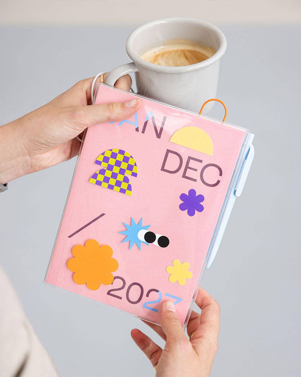 Dusty pink 2027 mishmash planner with time-block layout, featuring a closed planner with a pink cover and visible binding.