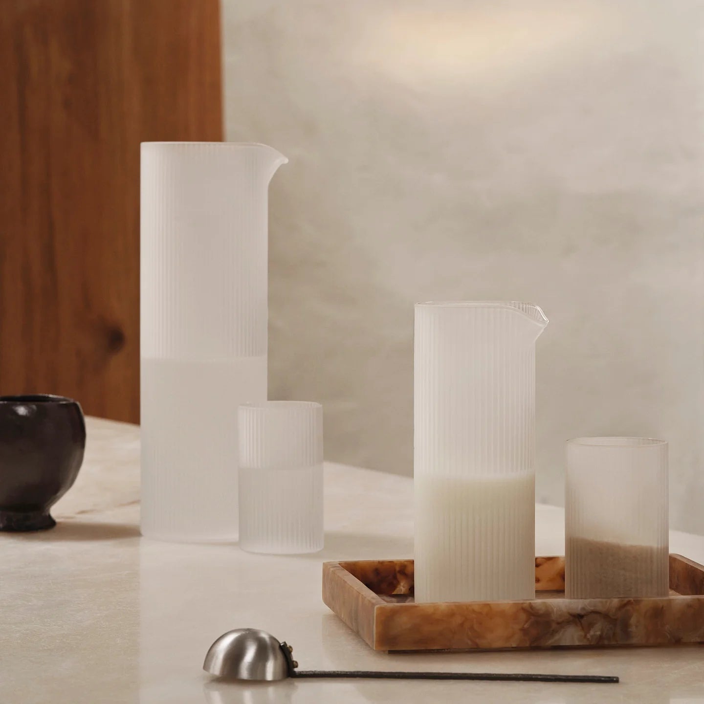 Ferm Living Ripple Water Jug in frosted glass with a textured, rippled design for serving water or beverages.