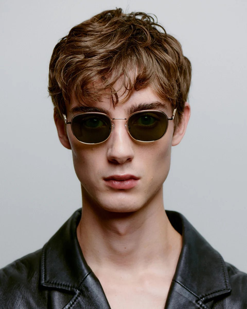 Gold Hello sunglasses by A. Kjaerbede with sleek rounded frames and tinted lenses, stylish eyewear for a modern look.