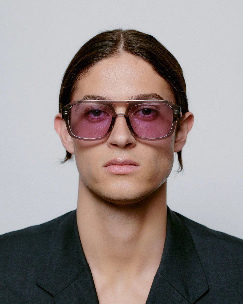 Grey transparent Kaya sunglasses by A. Kjaerbede with sleek, modern design and tinted lenses for stylish sun protection.