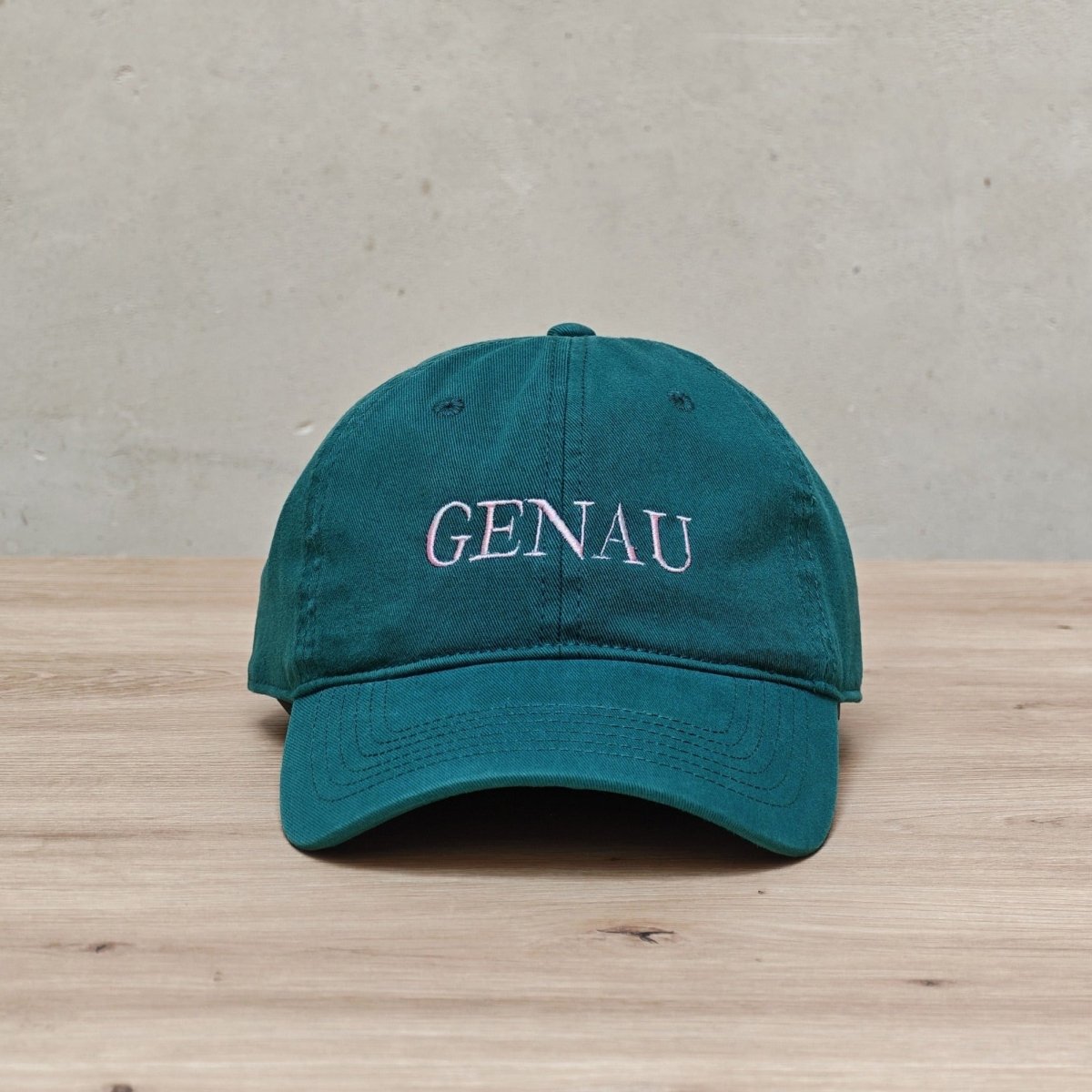 Embroidered 'GENAU' cap by Hallesches Haus with detailed stitching and adjustable strap, stylish headwear for casual wear.