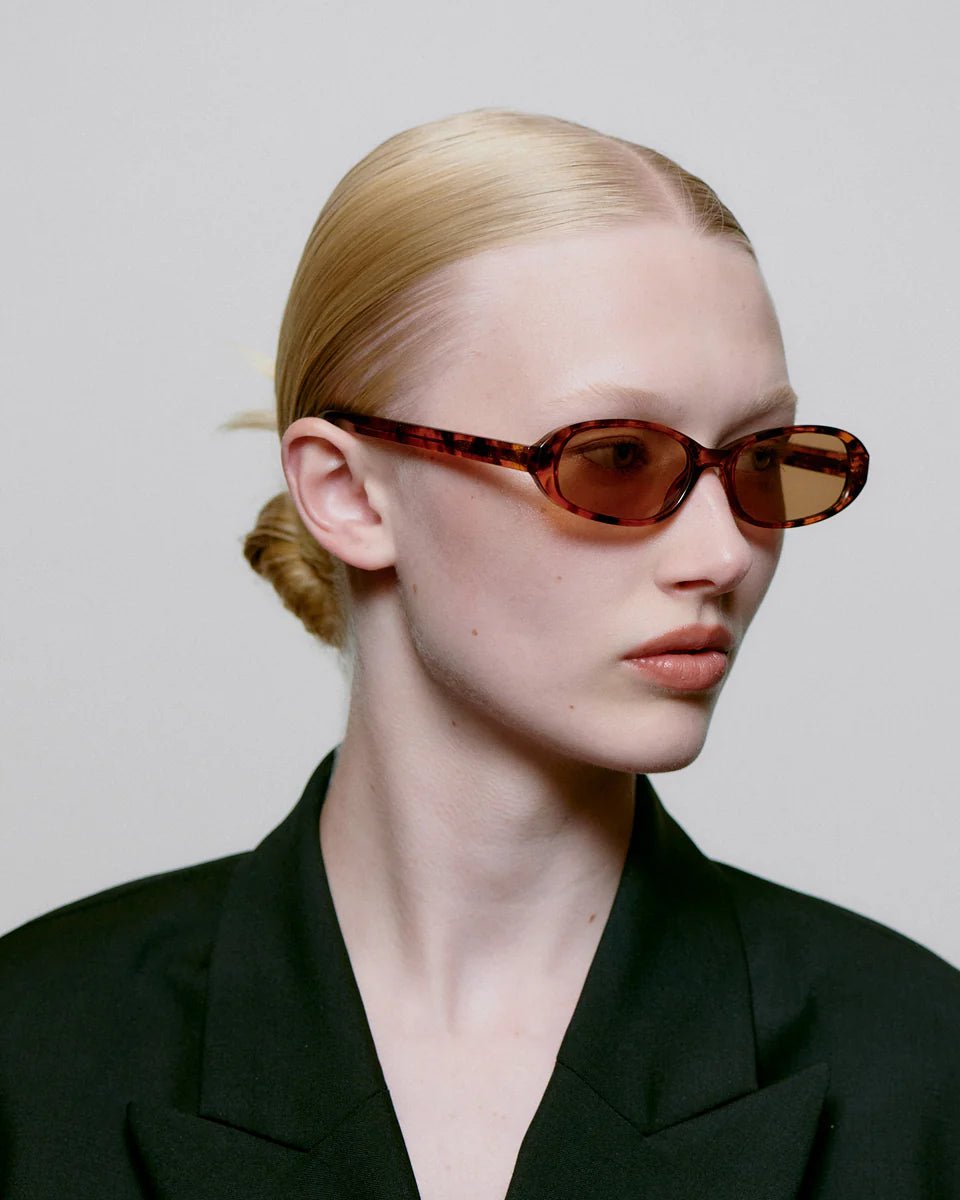 A. Kjaerbede Macy sunglasses with havana frames and dark tinted lenses, stylishly displayed.