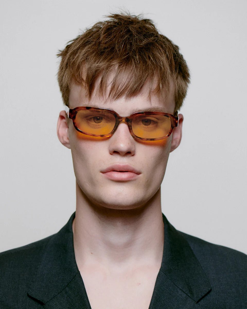 Havana-style Will sunglasses by A. Kjaerbede with rounded frames and tinted lenses, displayed on a neutral background.