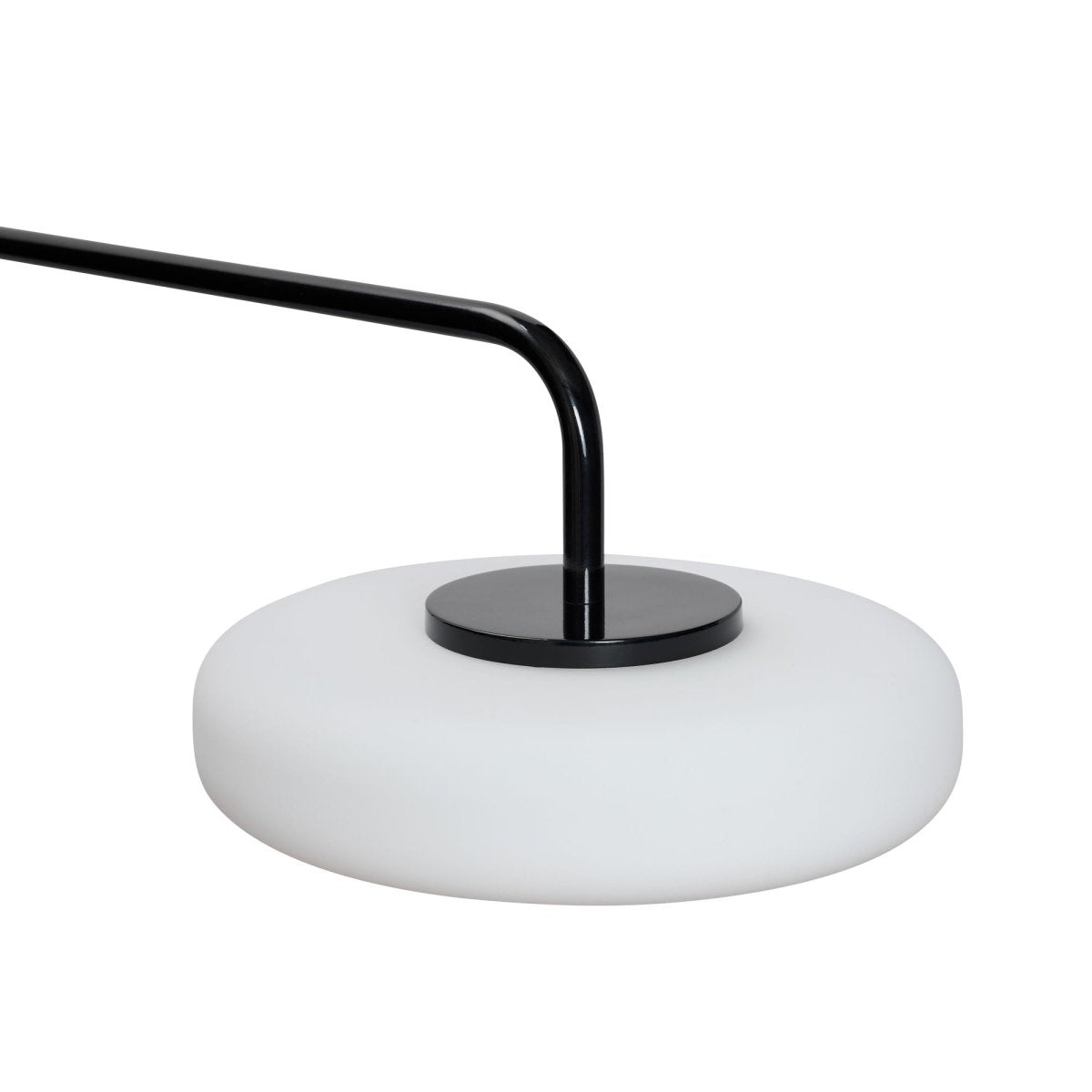 Black Hübsch Sway Wall Lamp mounted on a wall, showcasing its sleek, modern lighting design with a curved metal arm.
