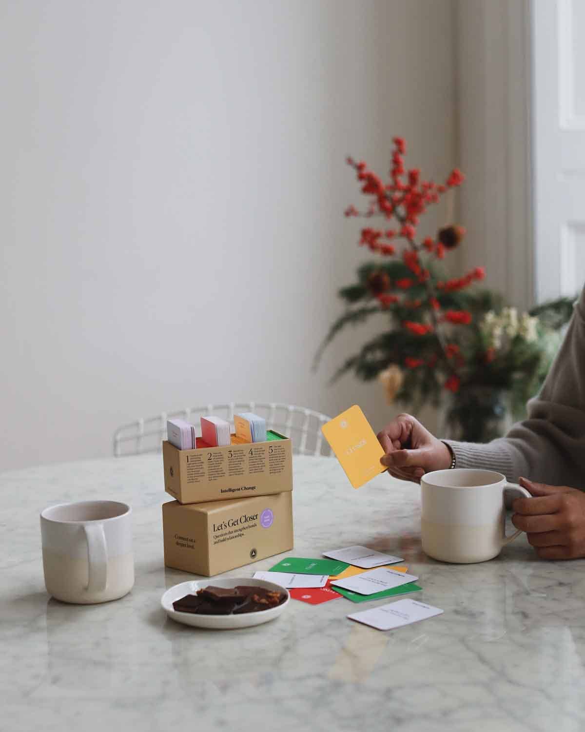 Let's Get Closer Family Edition bonding question card game by Intelligent Change, featuring colorful cards with conversation prompts.