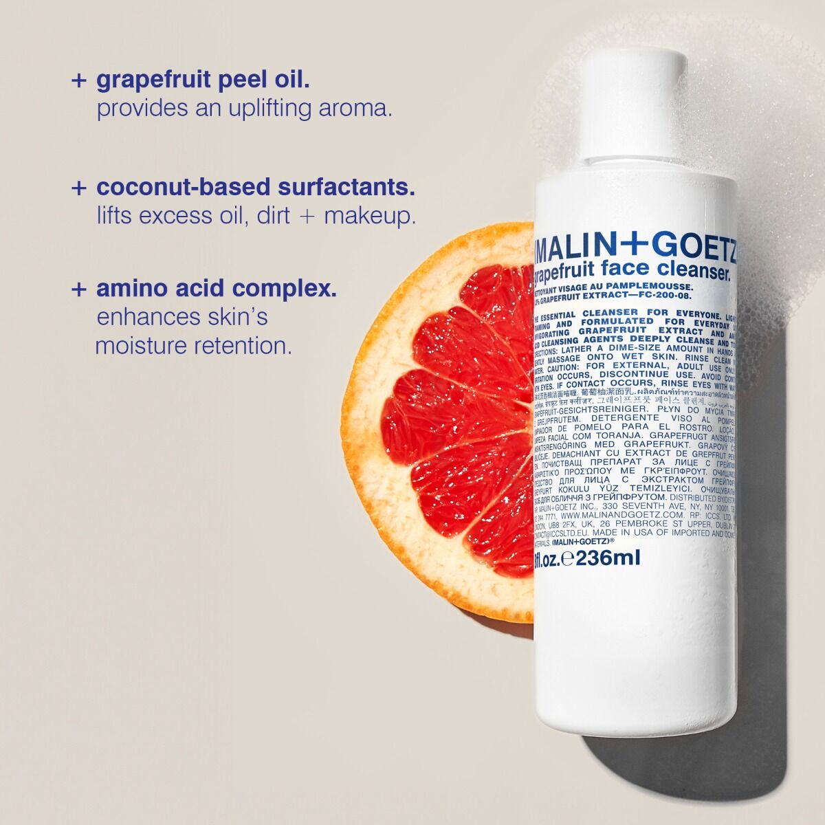 Malin+Goetz grapefruit face cleanser in clear bottle with pump, showing fresh citrus extract for skincare.
