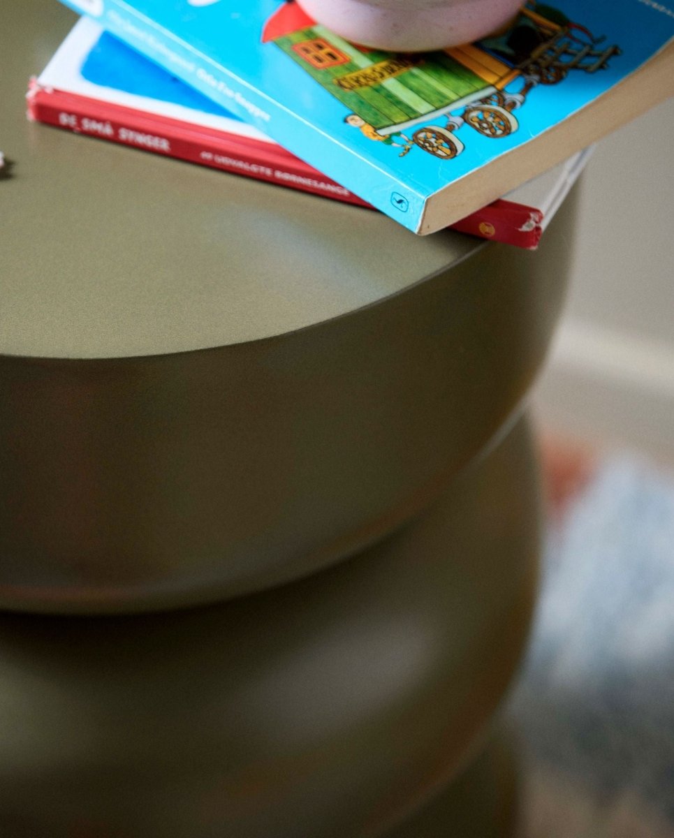 Dark green ALMA side table by Nordal A/S, featuring a sleek modern design with a round tabletop and slim legs.