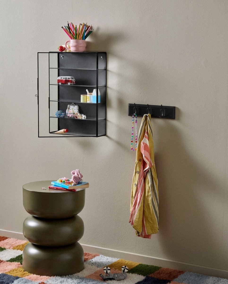 Dark green Nordal A/S Alma side table with a sleek, modern design, shown in a contemporary home setting.