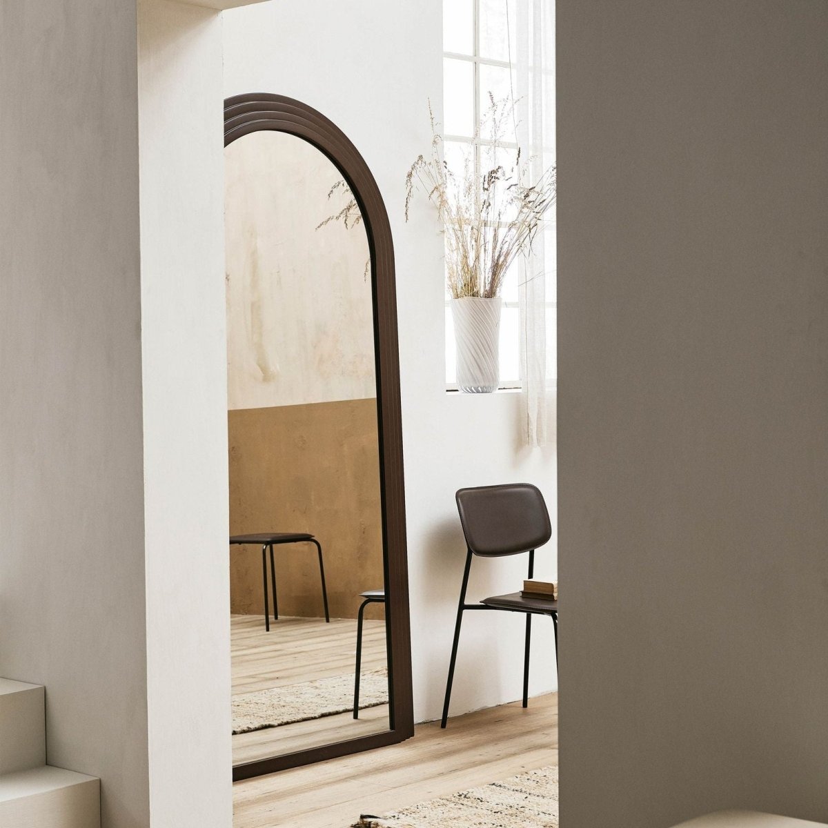 Rust-colored FALCO mirror by Nordal A/S featuring a sleek, modern design with a round frame and reflective glass surface.