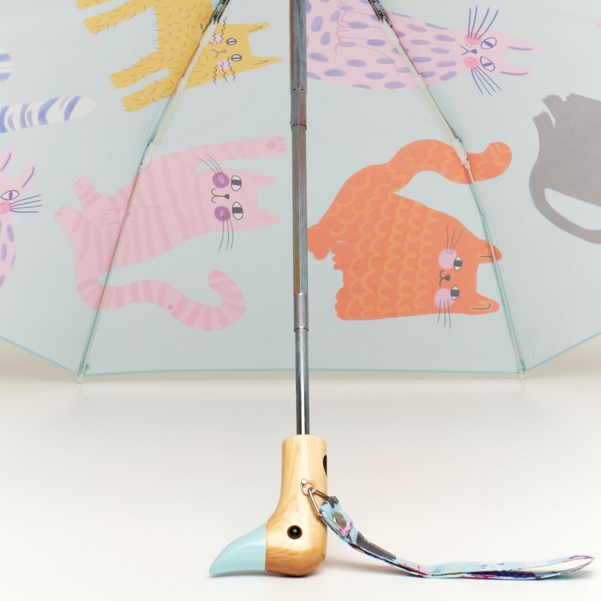 Blue Ice Arty Cats Duck Umbrella by Original Duckhead EU, featuring colorful cat illustrations, open and showing the canopy.