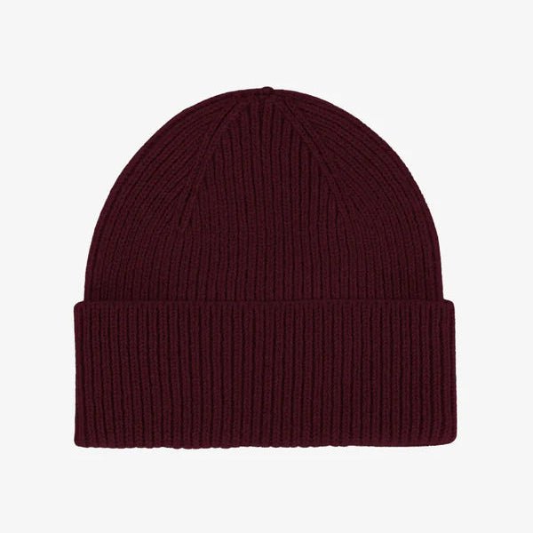 Maroon knit beanie on a white background