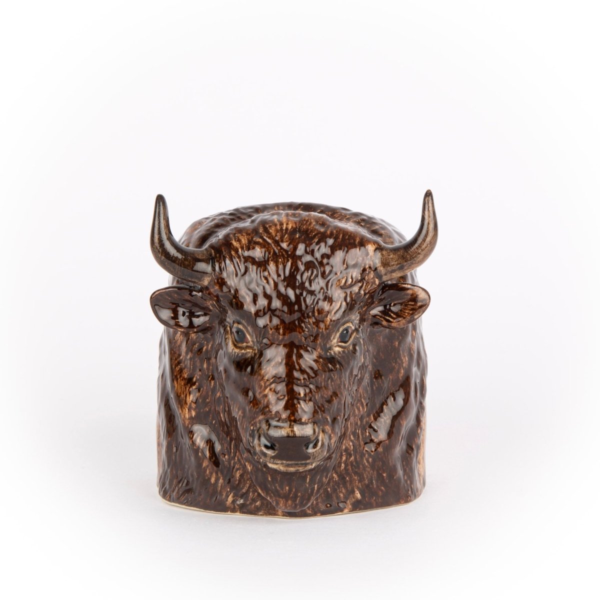 Ceramic buffalo head on a white background