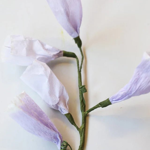 Purple artificial flowers on a white background