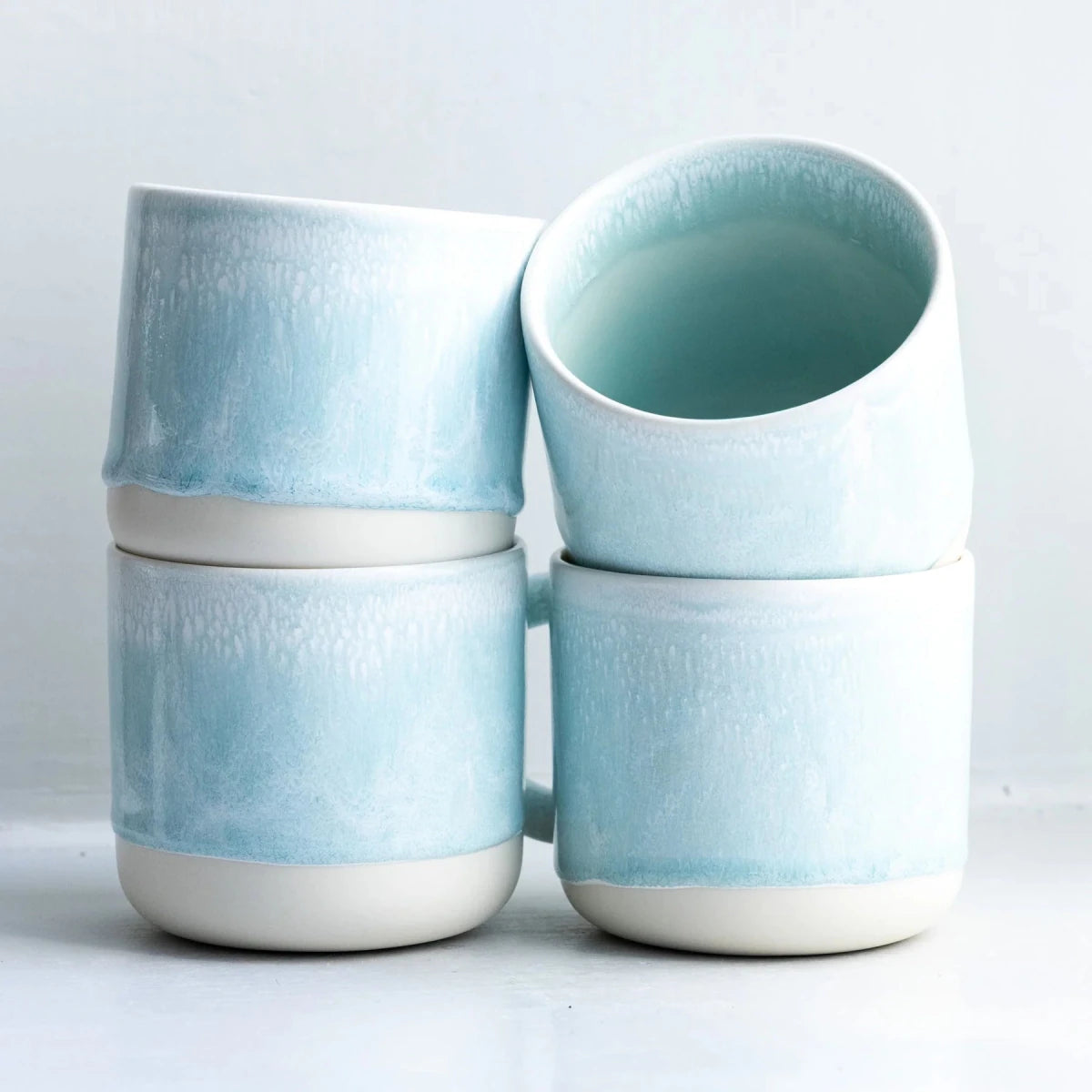 Spearmint ceramic Quench Cup by Studio Arhoj with a smooth, rounded shape and glossy finish, featuring a vibrant spearmint green color.