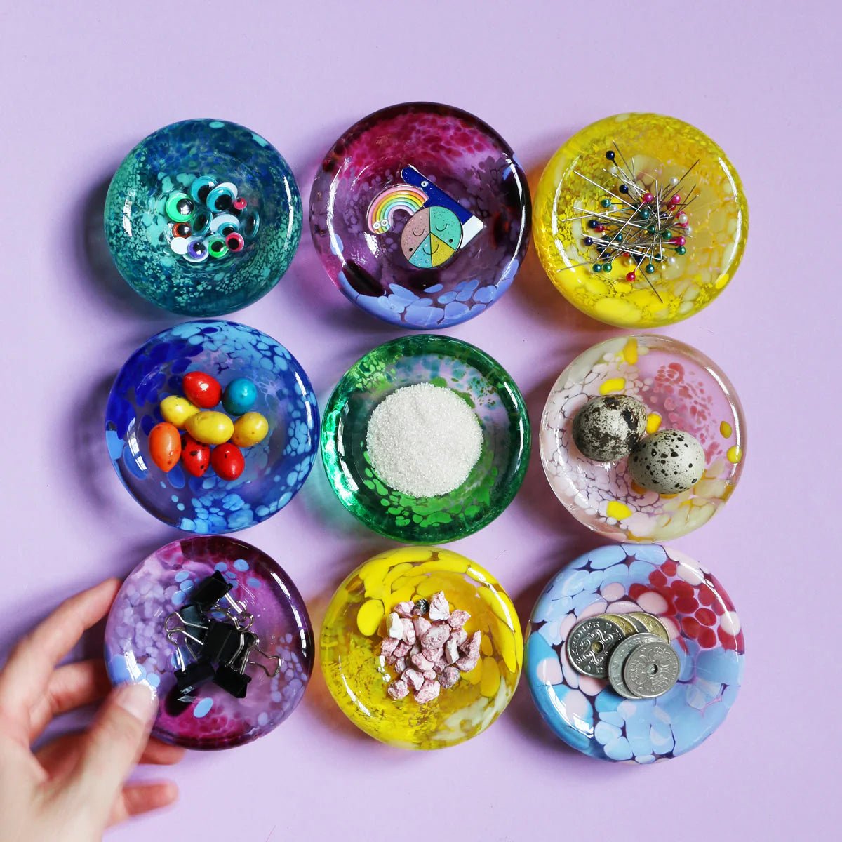 Studio Arhoj Puddle glass object featuring a colorful, abstract design on a clear glass surface.