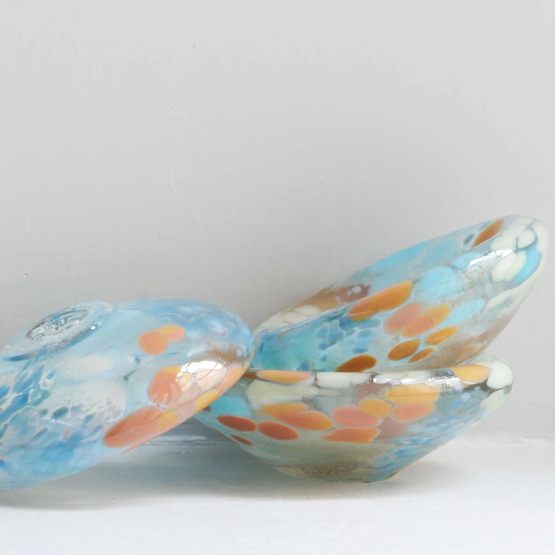 Studio Arhoj Puddle glass object featuring a colorful, translucent design with flowing shapes and vibrant hues.