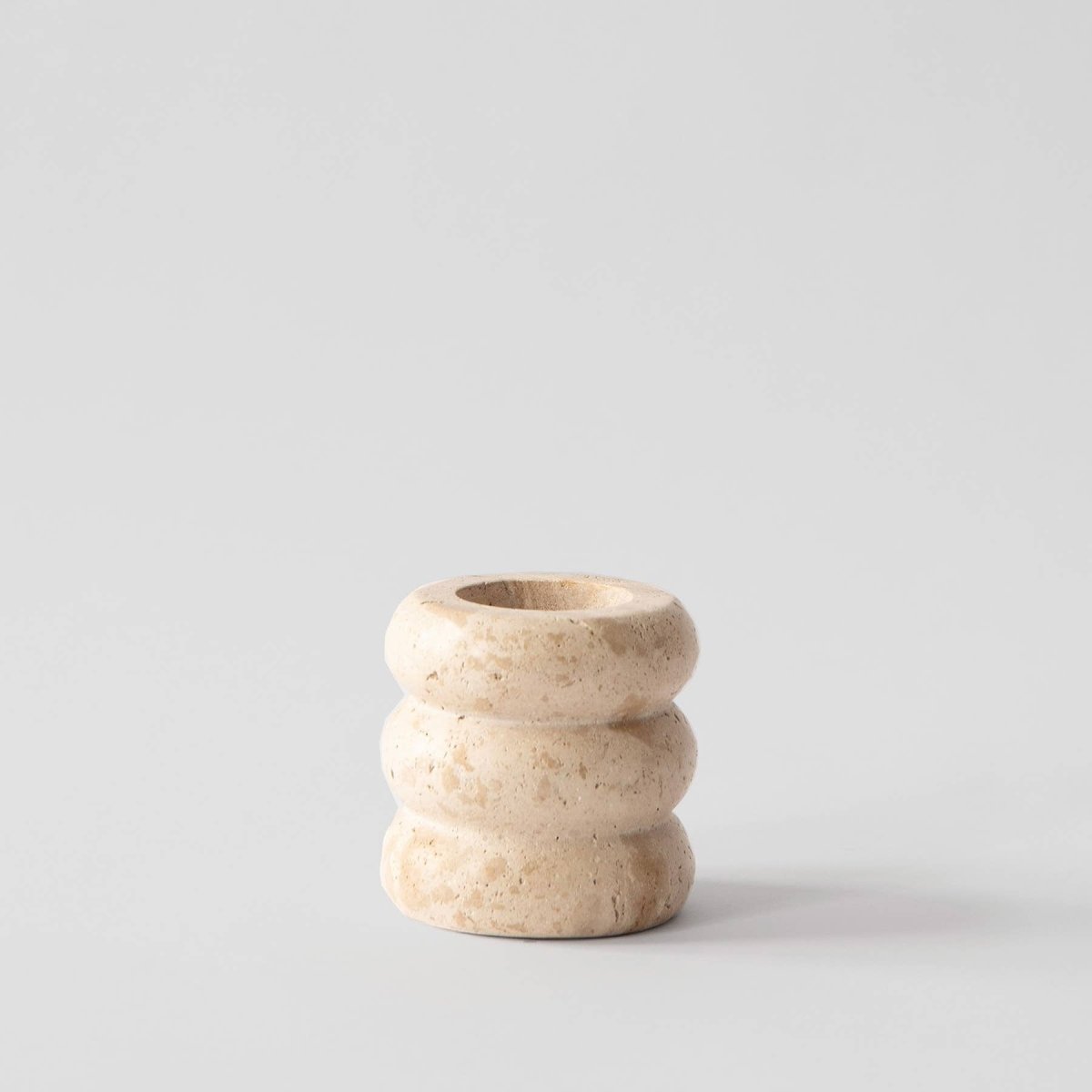 Beige ceramic vase on a light gray background