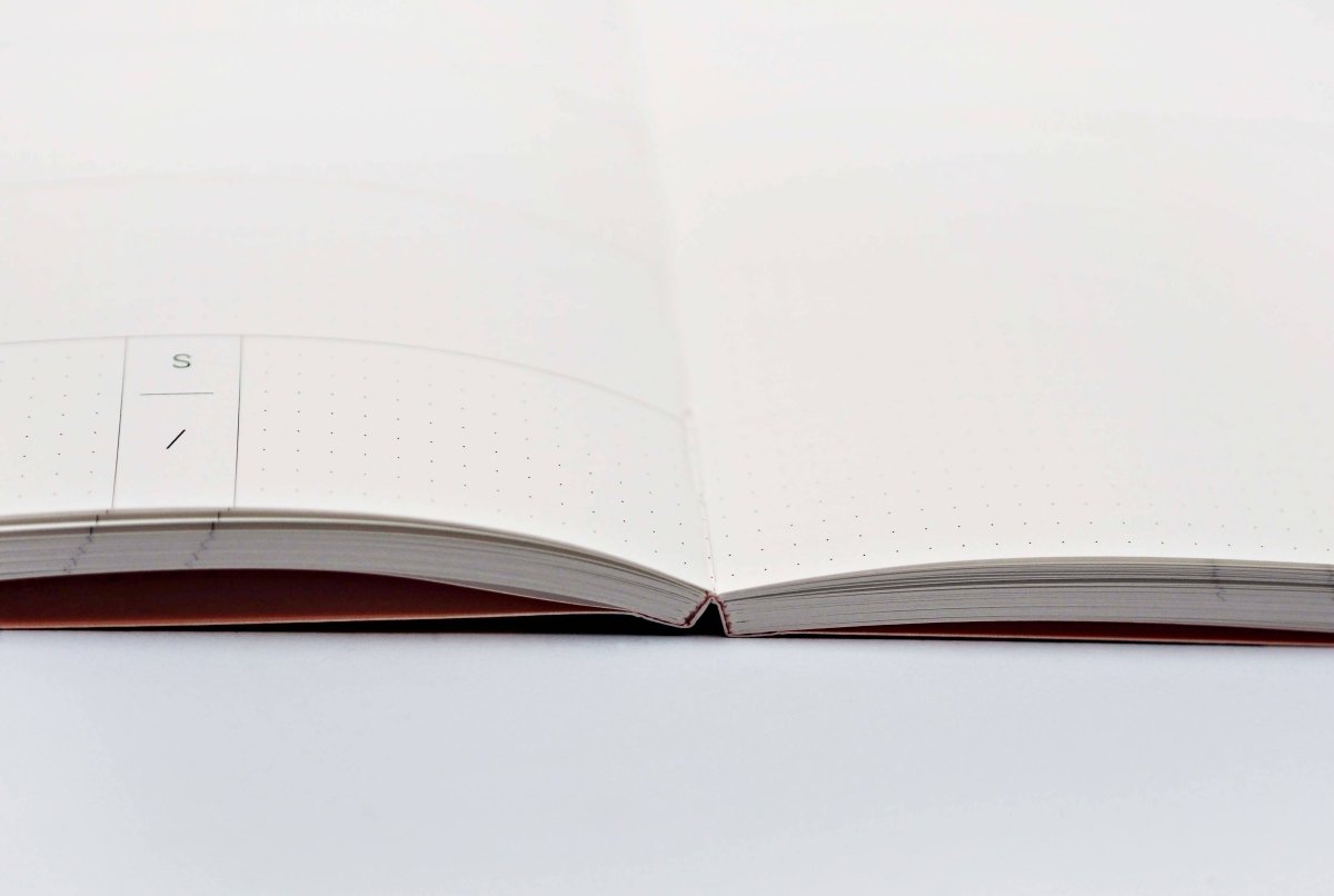 Overlay Flowers No. 1 weekly planner book by The Completist with a floral cover design and lay-flat layout for easy planning.