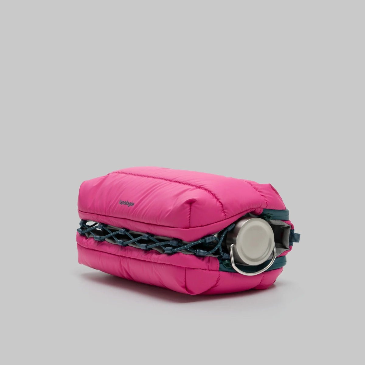 Large pink puffy bottle bag from topologie on a grey background