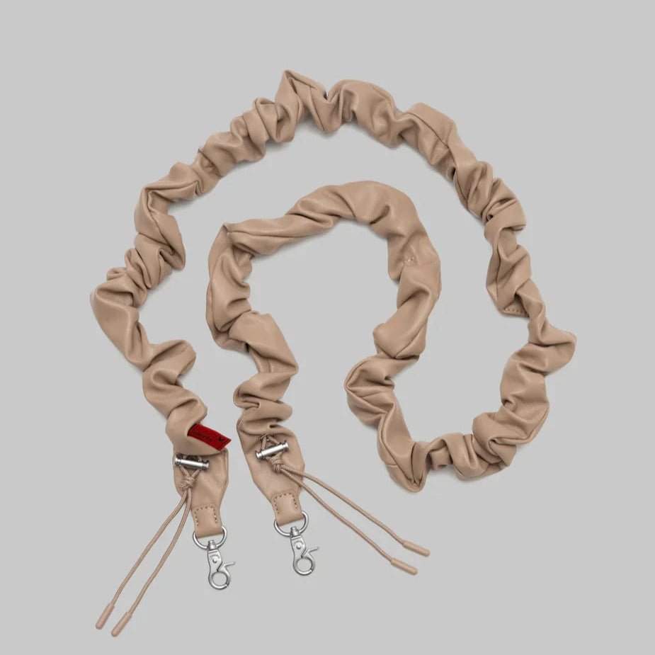 Topologie bungee strap for bags, black elastic cord with metal hooks, designed for secure attachment and versatile use.