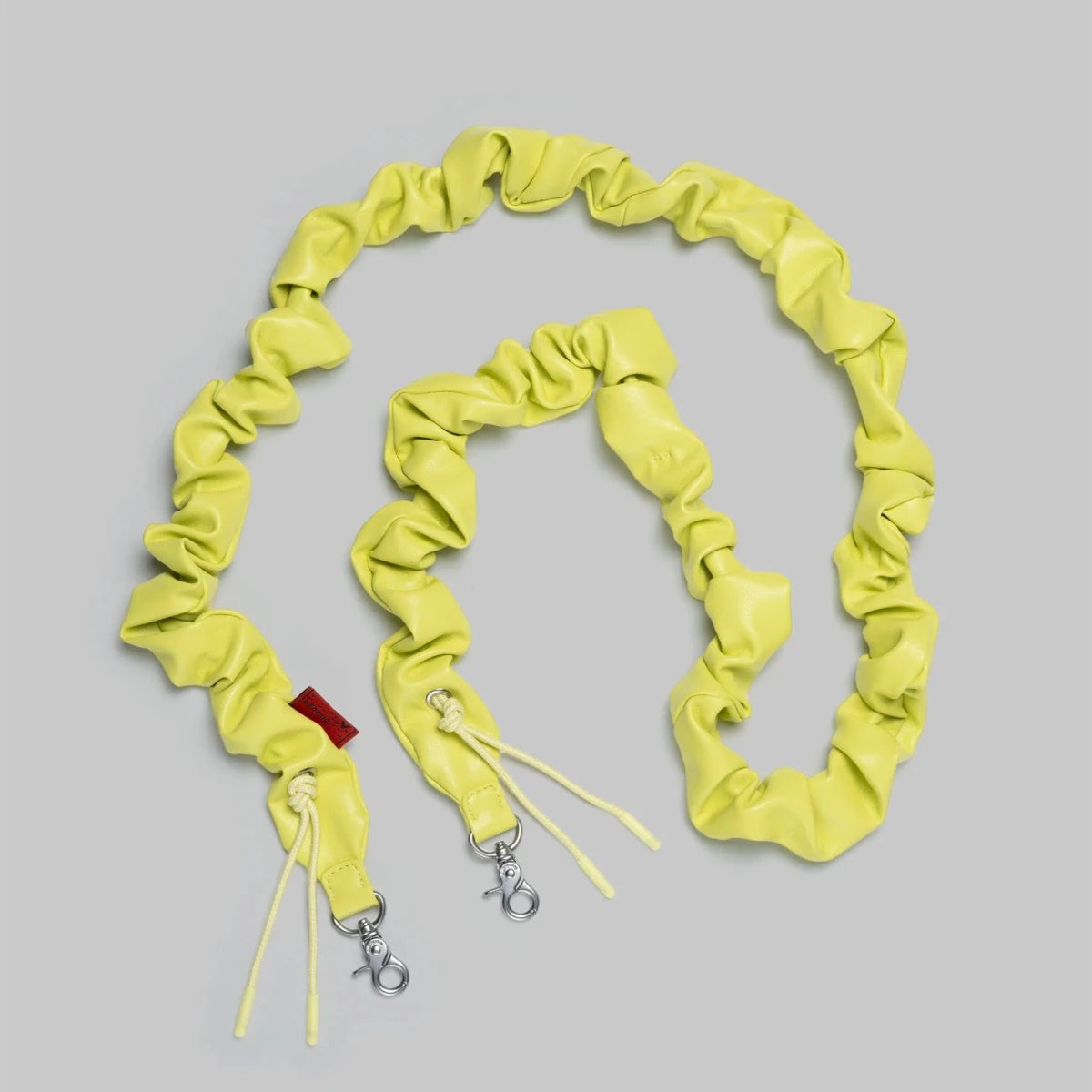Topologie Bungee Strap for Bags, durable elastic strap with metal hooks, designed to secure and customize bag closures or accessories.