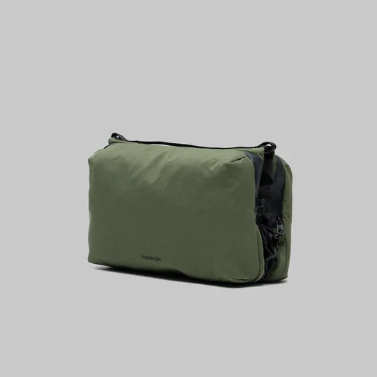 Large Topologie Bottle Sacoche bag with adjustable strap and minimalist design, ideal for carrying bottles comfortably.