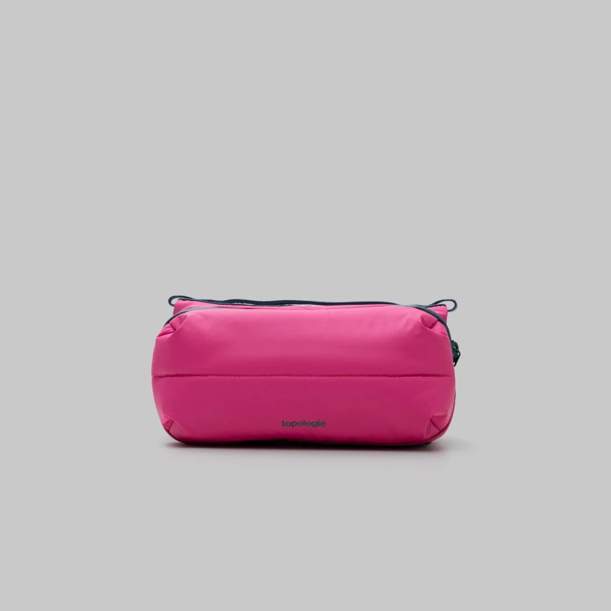 Pink puffy bottle bag with black accents on a light gray background