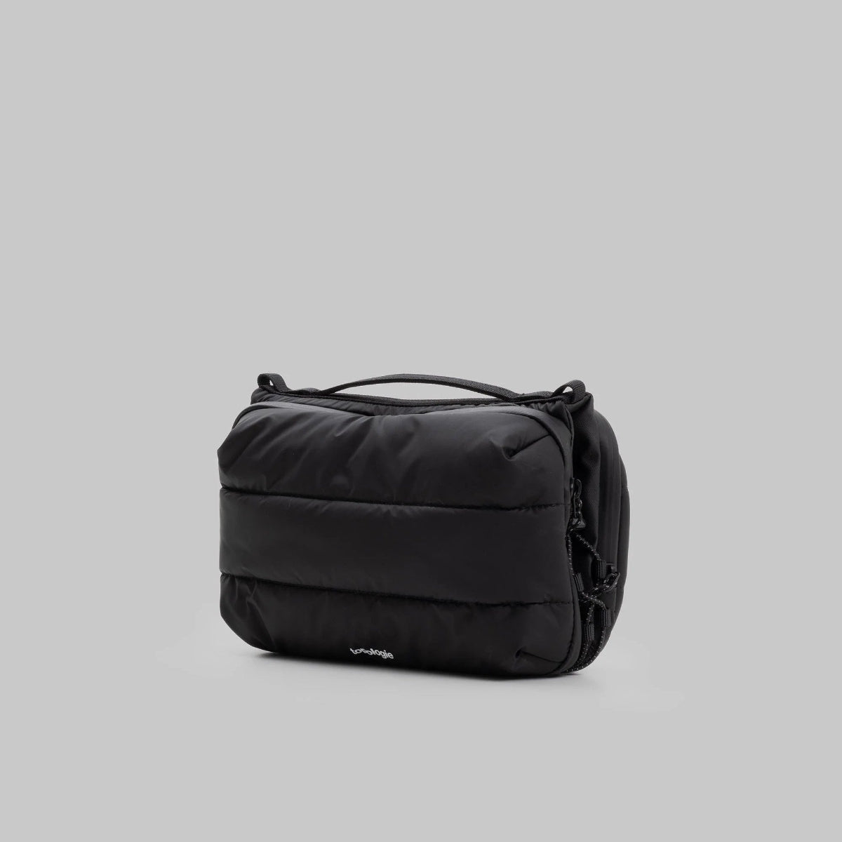 large puffy black bottle bag from Topologie on a grey background